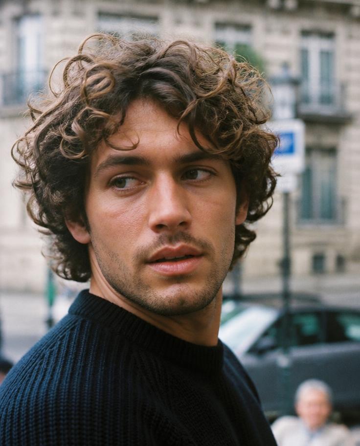 Man with medium length loose curls